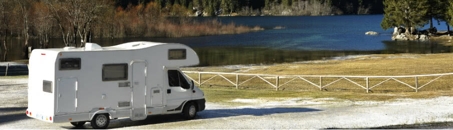 white campervan parked near the lake