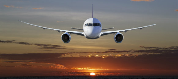 airplane flying at sunset in farnborough airport