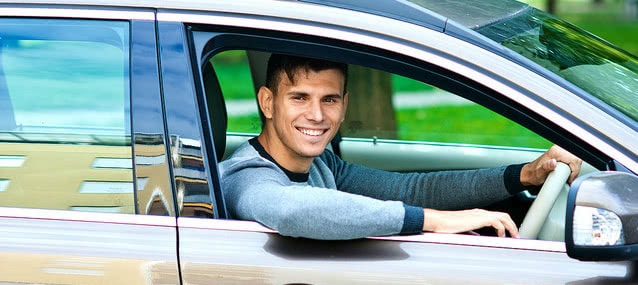 man seating in his rental car