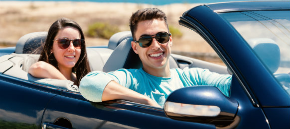 couple riding in a convertible car