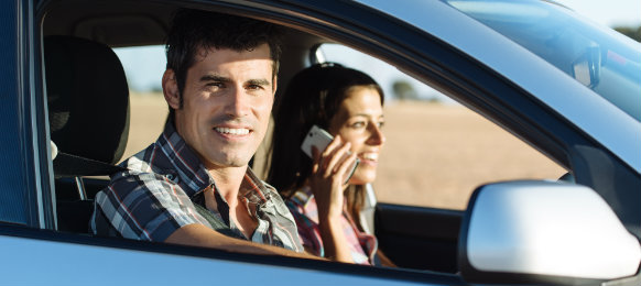 couple inside their blue new car