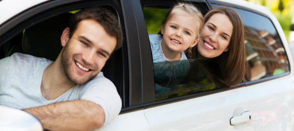 happy family posing inside their new car