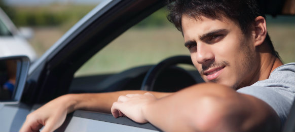 man smiling while in the car