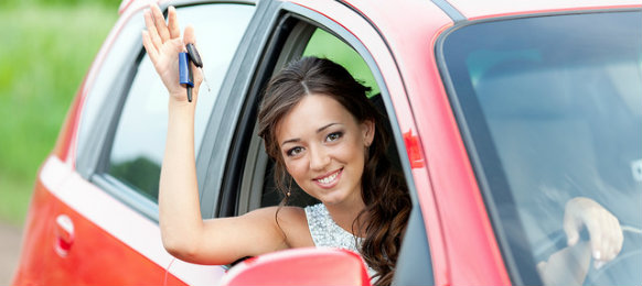 woman holding car key in a red car